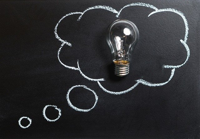 Drawing of a light bulb inside a bubble on a blackboard